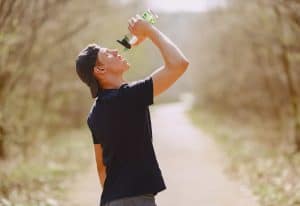 Man drinking water while on a run